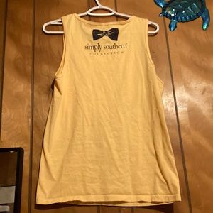 It is from simply southern, is yellow, and has a flamingo on it with no sleeves